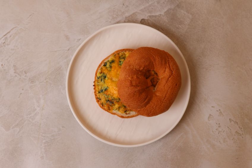 GF + Vegan Bagel Breakfast Sandwich - Mixed Veggie with Spinach & Sun-Dried Tomatoes with Vegan Cheddar